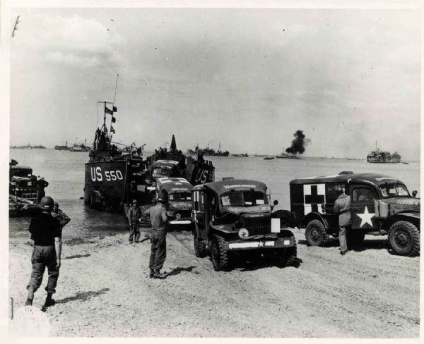 Original World War II 10 x 8 Black and White Glossy Wire Photo -- Ferry Unloads Army Ambulances on French Beach -- Near Fine