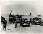 Original World War II 10 x 8 Black and White Glossy Wire Photo -- Ferry Unloads Army Ambulances on French Beach -- Near Fine