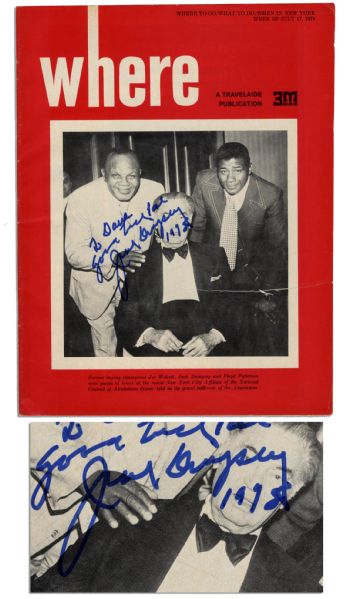Jack Dempsey Signs His Photo on a Travel Magazine Cover