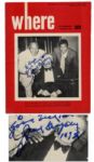 Jack Dempsey Signs His Photo on a Travel Magazine Cover