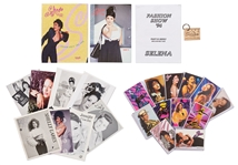 Lot of Items Related to Selena Quintanilla -- Includes Two 1996 Catalogs from Her Clothing Line, 1994 Fashion Show Publication, Branded Key Ring, Photos & More