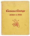 H.A. Rey Signed First Edition of ''Curious George Rides a Bike'' with Rey Also Drawing an Illustration of the Curious Monkey