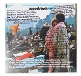 Woodstock Album Signed by Photographer Burk Uzzle & the Iconic Couple -- ...Someone with a guitar here, someone making love there, someone smoking a joint...a bombardment of the senses...