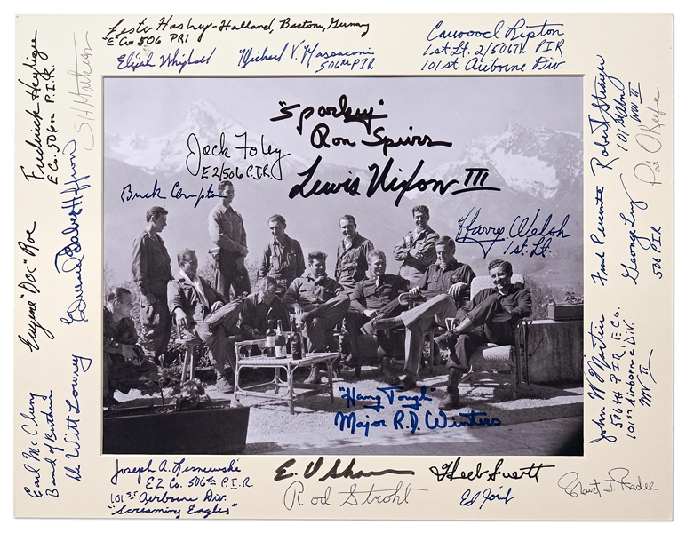 Photo Signed by 27 Soldiers of ''Easy Company'', AKA the Band of Brothers at the Eagle's Nest in May 1945 -- Includes Signature of Company Commander Dick Winters Who Writes His Motto ''Hang Tough''