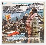 Woodstock Album Signed by Photographer Burk Uzzle & the Iconic Couple -- "Someone with a guitar here, someone making love there, someone smoking a joint...a bombardment of the senses"