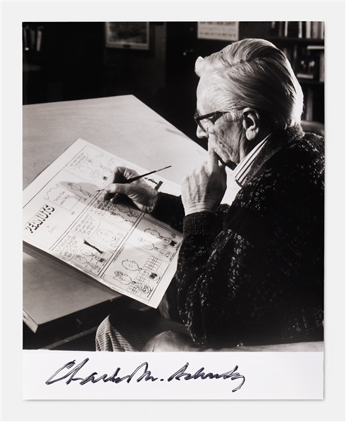 Charles Schulz Signed 8 x 10 Photo -- Unique Image Shows Schulz Drawing a Peanuts Comic Strip